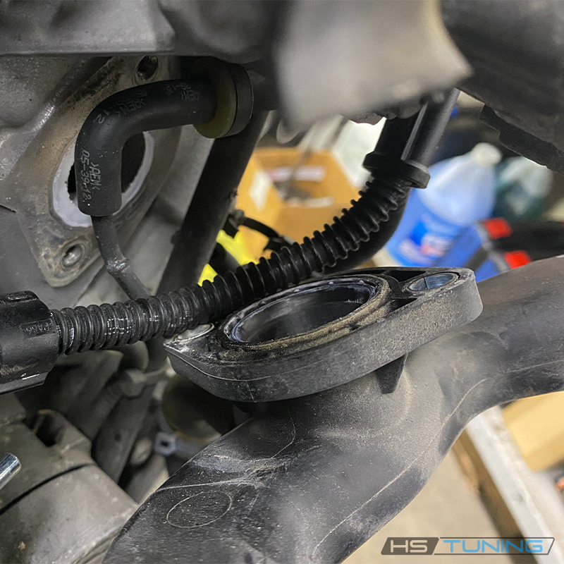Coolant-pipe joint service context for 06E-121-119-K seal; pipe not included, source photo 4