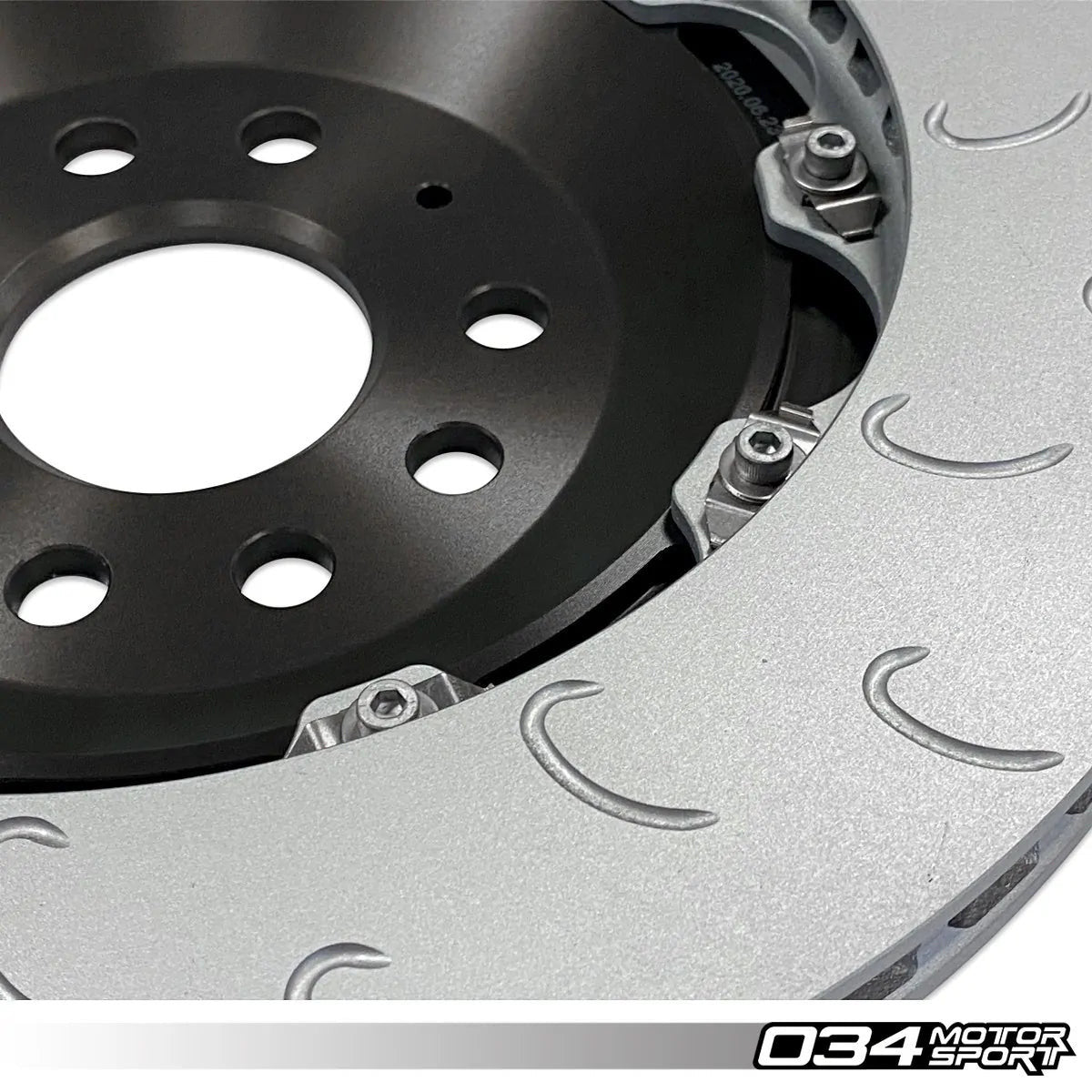 HS Tuning 034Motorsport 2-piece floating rear brake rotor with J-slot design and black aluminum hat for MQB vehicles.