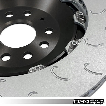 HS Tuning 034Motorsport 2-piece floating rear brake rotor with J-slot design and black aluminum hat for MQB vehicles.