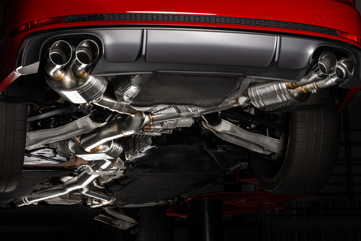 HS Tuning APR catback exhaust system installed on an Audi B9 S4, featuring polished quad tips and stainless piping.