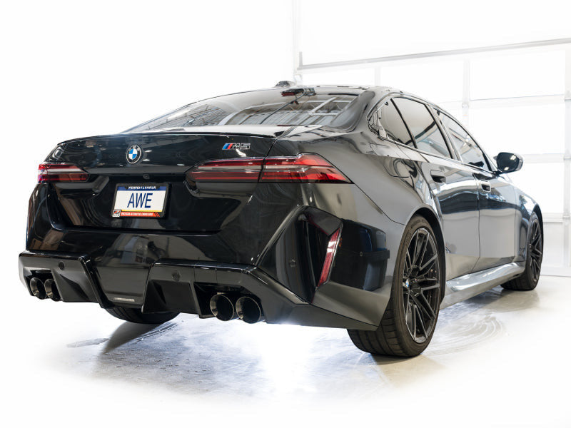 HS Tuning AWE Tuning Track Edition cat-back exhaust with diamond black tips installed on a black BMW M5 rear view