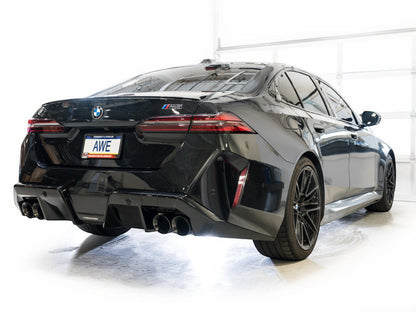HS Tuning AWE Tuning Track Edition cat-back exhaust with diamond black tips installed on a black BMW M5 rear view