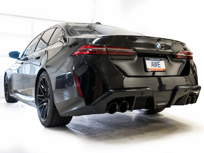HS Tuning AWE Tuning Track Edition cat-back exhaust with diamond black tips installed on a black BMW M5 rear view