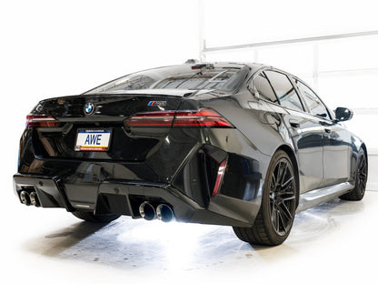 HS Tuning AWE Tuning Track Edition cat-back exhaust with chrome silver tips installed on a black BMW M5 rear view