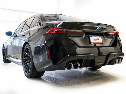 HS Tuning AWE Tuning Track Edition cat-back exhaust with chrome silver tips installed on a black BMW M5 rear view