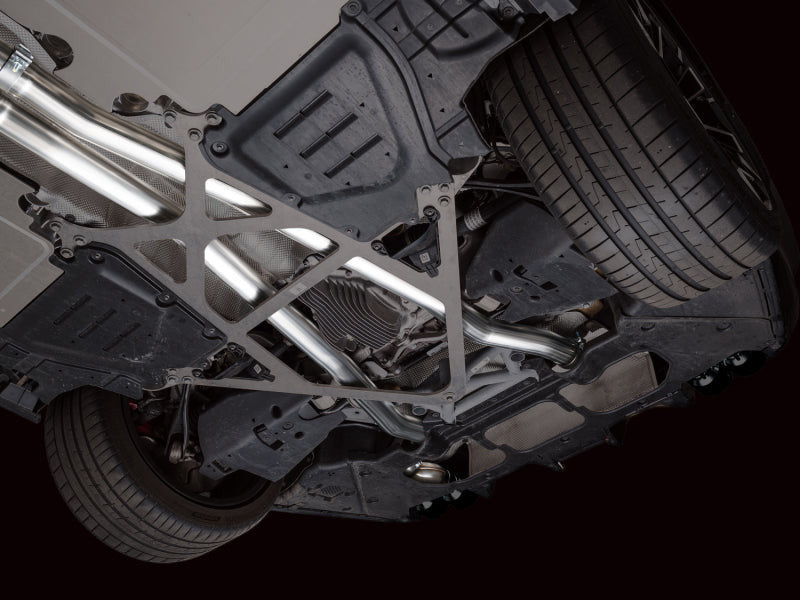 HS Tuning AWE Tuning Track Edition cat-back exhaust system installed under a BMW M5, showing stainless steel piping.