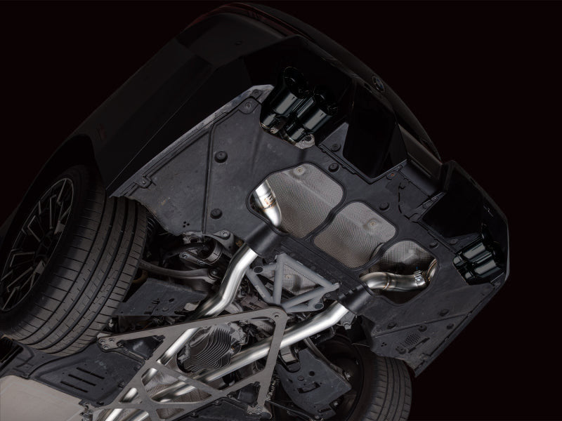 HS Tuning AWE Tuning Track Edition cat-back exhaust with diamond black tips installed on a BMW G90 M5 undercarriage