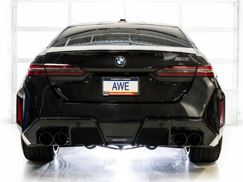 Rear view of a black BMW M5 featuring the HS Tuning AWE Tuning Track Edition cat-back exhaust with diamond black tips.