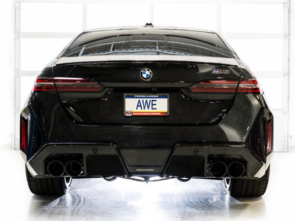 Rear view of a black BMW M5 featuring the HS Tuning AWE Tuning Track Edition cat-back exhaust with diamond black tips.
