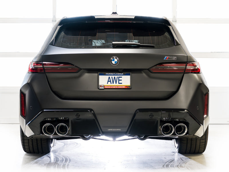 Rear view of a matte black BMW M5 with HS Tuning AWE Tuning Track Edition cat-back exhaust and chrome silver tips