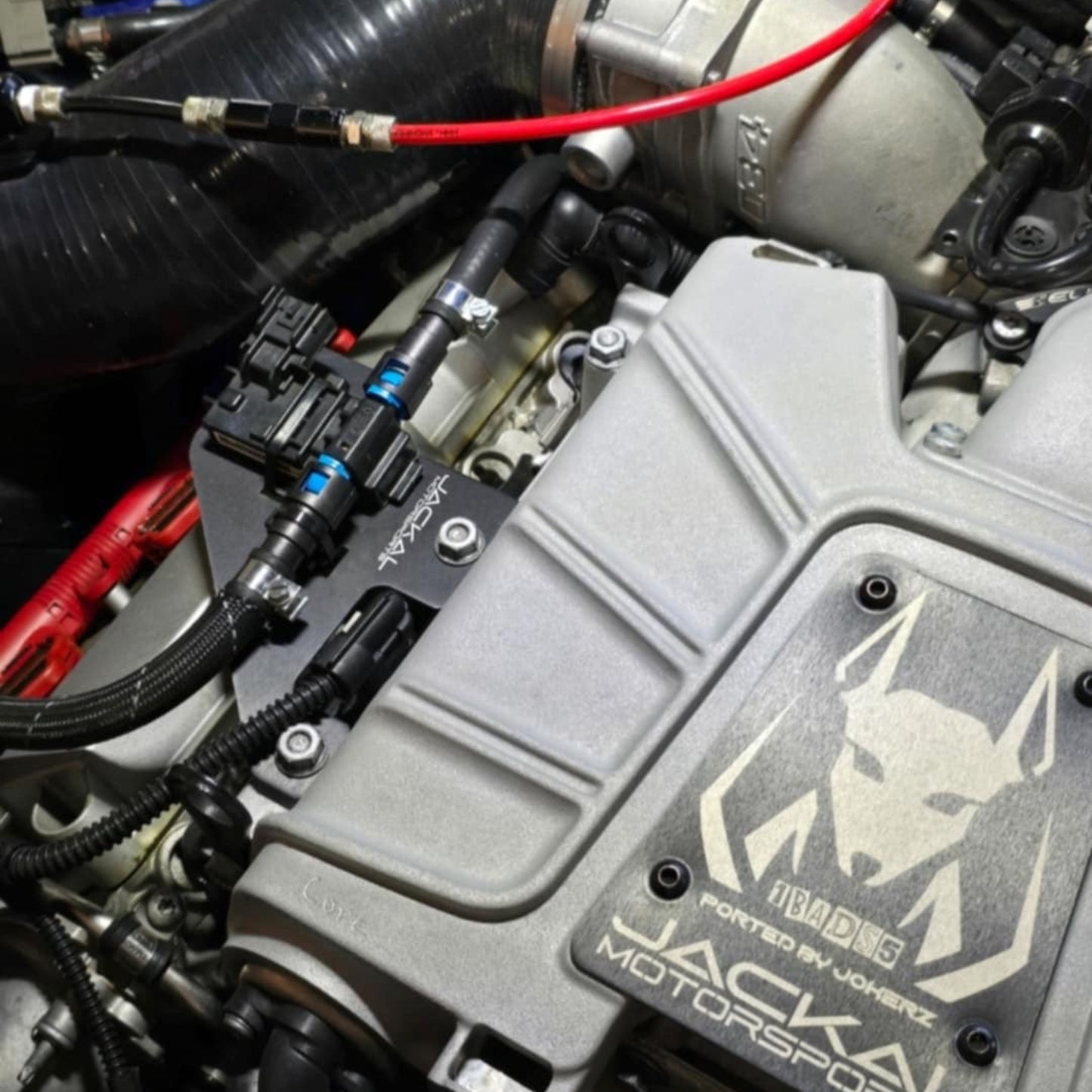 HS Tuning Jackal Motorsports ethanol sensor bracket installed on an Audi 3.0TFSI engine bay with fuel lines