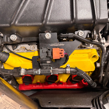 HS Tuning Jackal Motorsports ethanol sensor bracket installed on an Audi 3.0TFSI engine with yellow valve covers