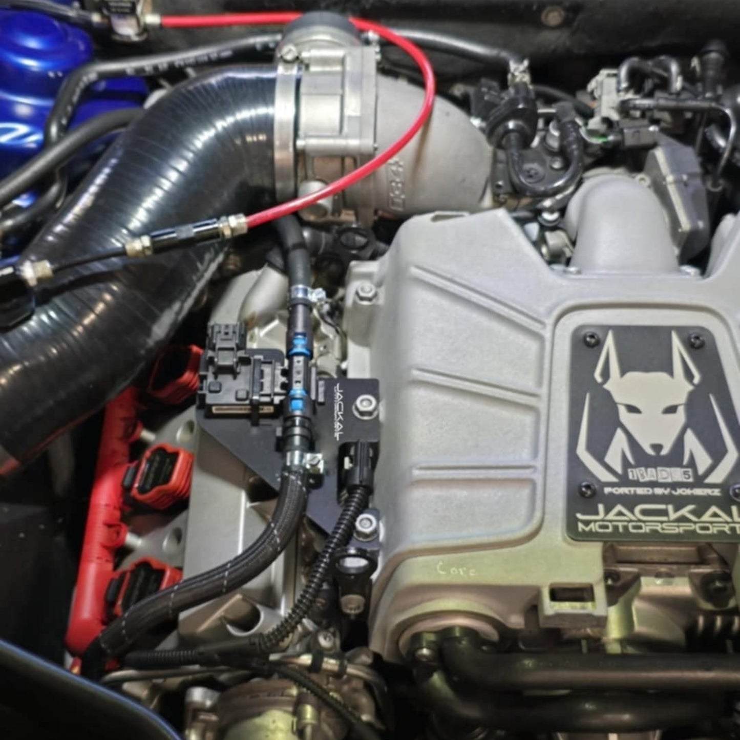 HS Tuning Jackal Motorsports ethanol sensor bracket installed on an Audi 3.0TFSI engine bay with fuel lines