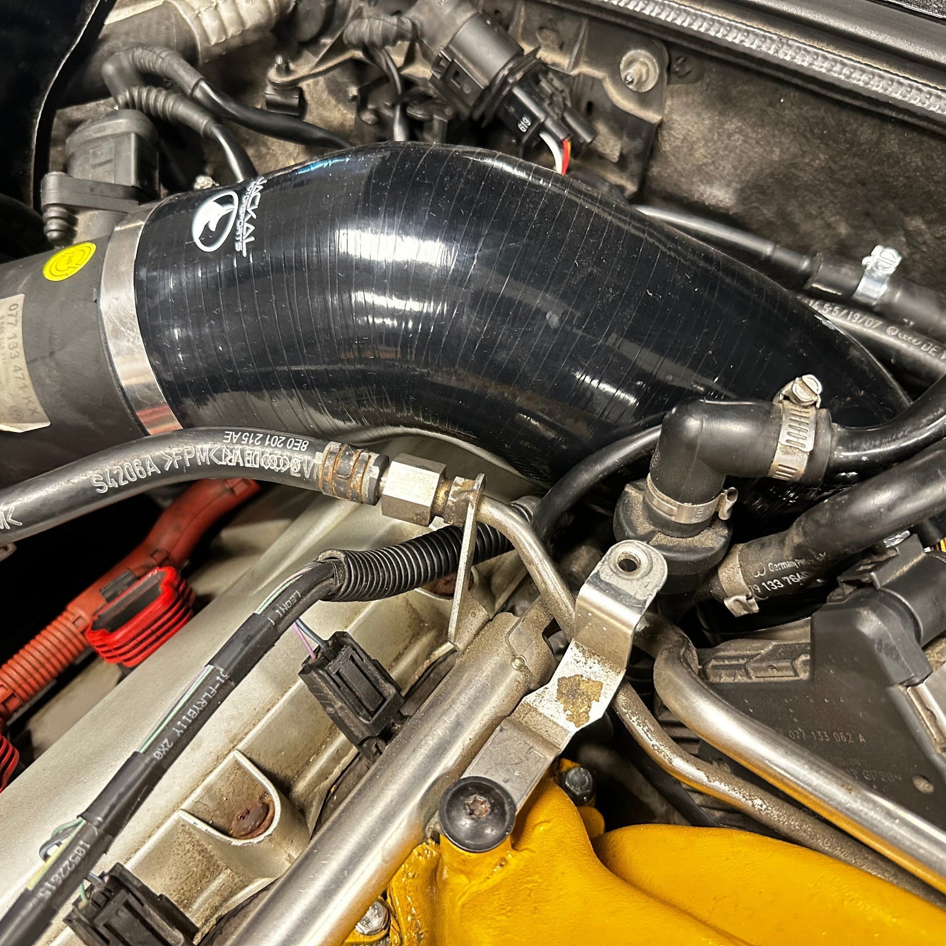 HS Tuning Jackal Motorsports black silicone intake pipe installed in a B6/B7 S4 engine bay