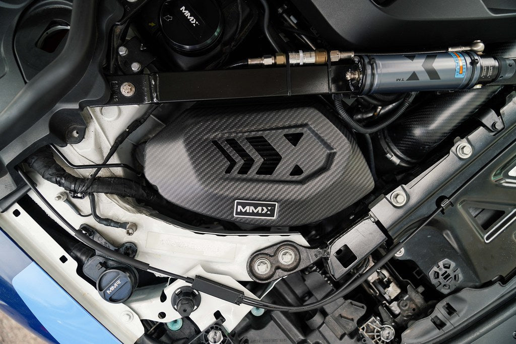 HS Tuning MMX Performance carbon fiber air intake system installed in a BMW G8X engine bay with 3K twill finish.