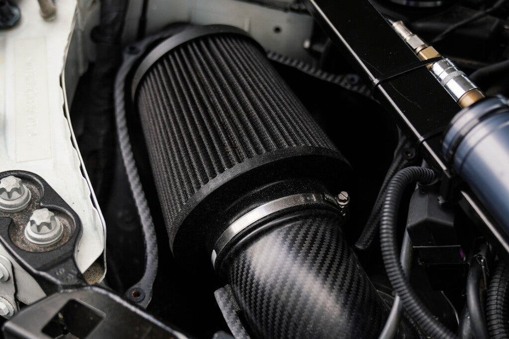 HS Tuning MMX Performance carbon fiber intake system with a high-flow cone filter installed in a BMW engine bay. MMX Performance G8X M2 / M3 / M4 Carbon Fiber Intake
