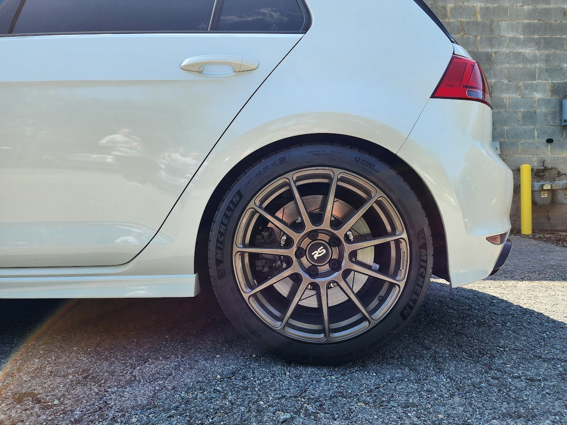 HS Tuning B2BFAB mild lift kit installed on a white VW MQB vehicle, showing increased ride height and wheel clearance.