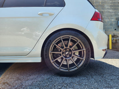 HS Tuning B2BFAB mild lift kit installed on a white VW MQB vehicle, showing increased ride height and wheel clearance.