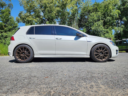 HS Tuning white VW Golf hatchback with B2BFAB 0.75-inch mild lift kit installed, parked on asphalt.