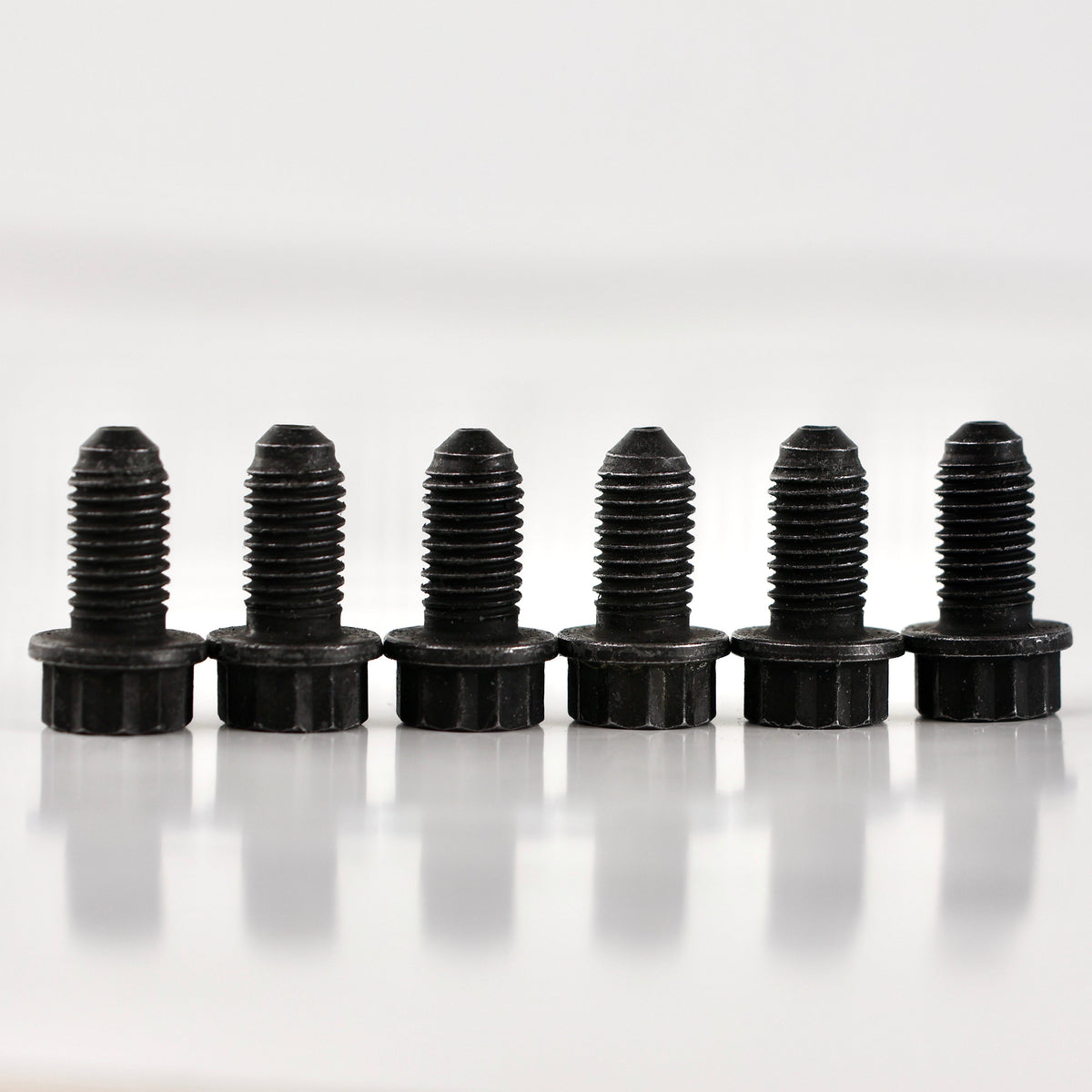 HS Tuning genuine Volkswagen and Audi black metal pressure plate bolts lined up in a row on a white surface.